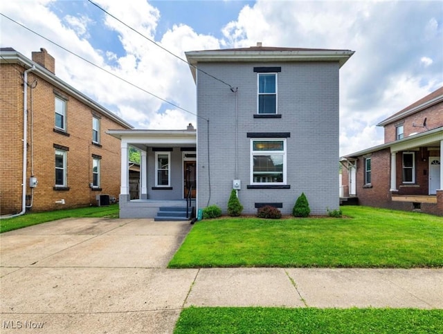 719 N 3rd St, Toronto, OH 43964 - traditional home with a porch, brick siding, and a front lawn