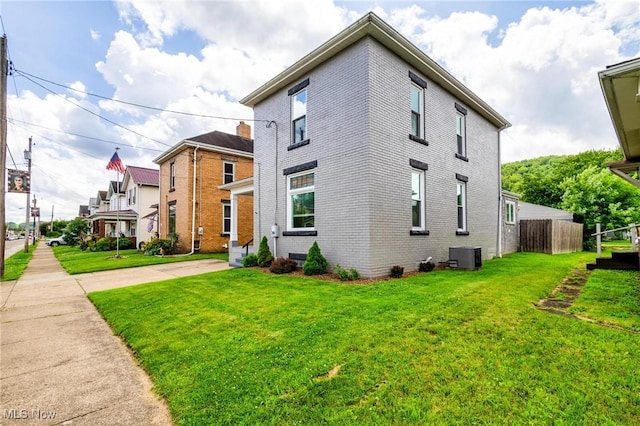 719 N 3rd St, Toronto, OH 43964 - view of home's exterior featuring a central AC unit and brick siding