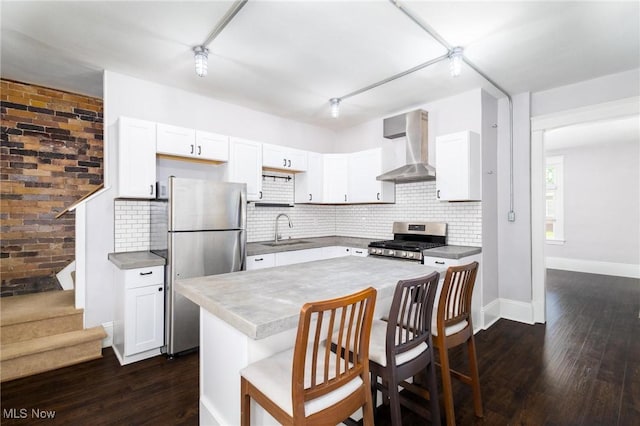 719 N 3rd St, Toronto, OH 43964 - kitchen featuring wall chimney range hood, stainless steel appliances, dark wood finished floors, and decorative backsplash