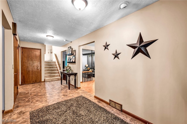 12938 Carter Rd, Leroy, OH 44077 - hallway featuring a textured ceiling and stairway