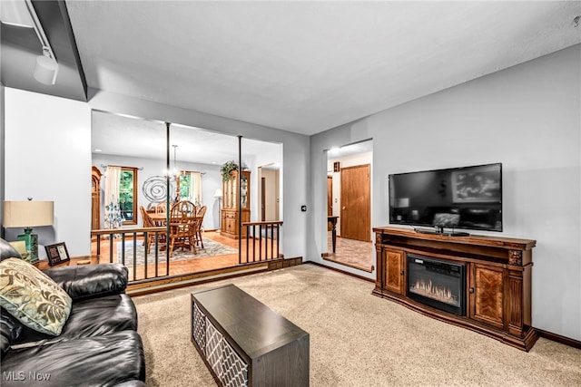 12938 Carter Rd, Leroy, OH 44077 - carpeted living area featuring a glass covered fireplace and a chandelier