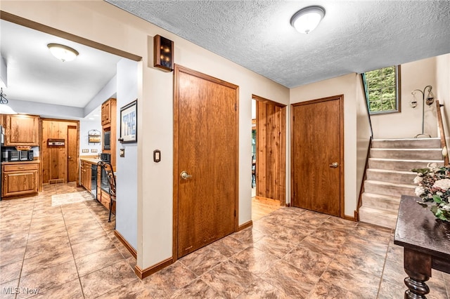 12938 Carter Rd, Leroy, OH 44077 - foyer entrance with stairs and a textured ceiling
