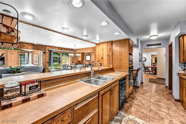 12938 Carter Rd, Leroy, OH 44077 - kitchen featuring a chandelier, brown cabinets, wood walls, hanging light fixtures, and open floor plan