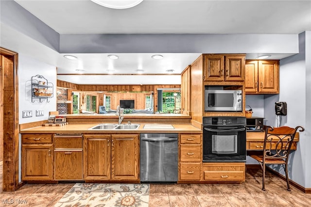 12938 Carter Rd, Leroy, OH 44077 - kitchen with stainless steel appliances, brown cabinets, a peninsula, recessed lighting, and light countertops