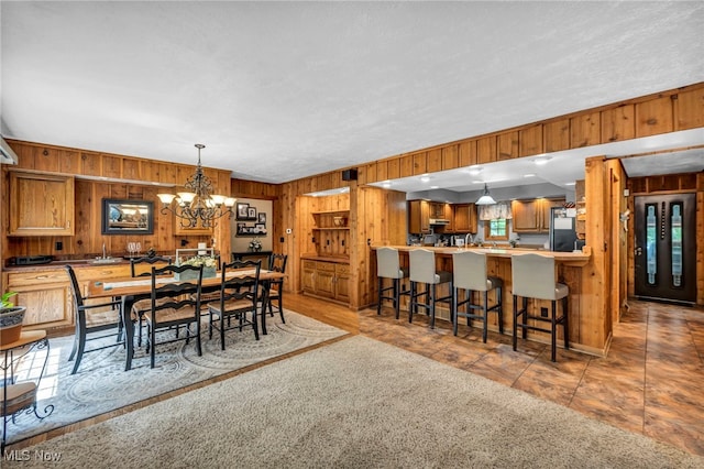 12938 Carter Rd, Leroy, OH 44077 - dining room with wood walls and a chandelier
