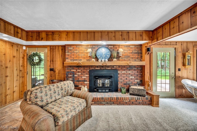 12938 Carter Rd, Leroy, OH 44077 - living room featuring wood walls, a wood stove, healthy amount of natural light, a textured ceiling, and carpet