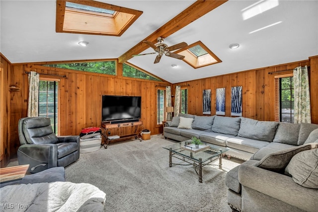 12938 Carter Rd, Leroy, OH 44077 - carpeted living area with a skylight, wood walls, healthy amount of natural light, and a ceiling fan