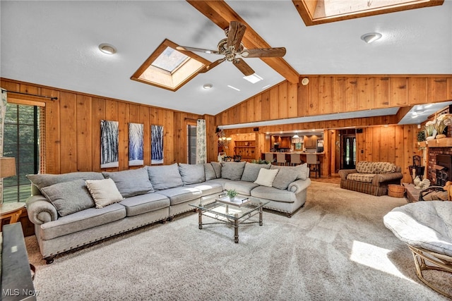 12938 Carter Rd, Leroy, OH 44077 - living area with a skylight, wood walls, ceiling fan, and carpet