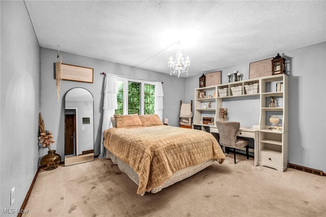 12938 Carter Rd, Leroy, OH 44077 - bedroom featuring carpet floors, a chandelier, a textured ceiling, arched walkways, and a desk