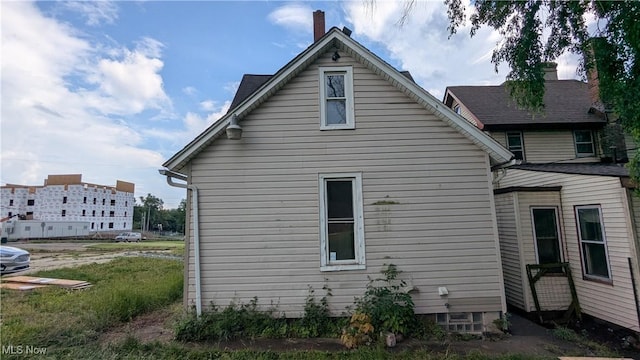 1111 2nd St NW, Canton, OH 44703 - view of side of home with a chimney