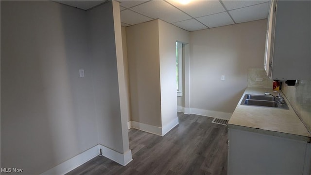 1111 2nd St NW, Canton, OH 44703 - kitchen with light countertops, a drop ceiling, and dark wood-type flooring