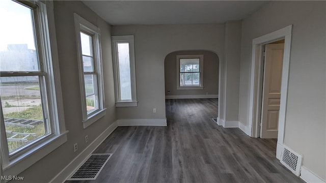 1111 2nd St NW, Canton, OH 44703 - spare room featuring arched walkways and dark wood-type flooring