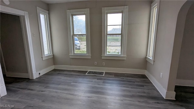 1111 2nd St NW, Canton, OH 44703 - spare room featuring arched walkways, plenty of natural light, and wood finished floors