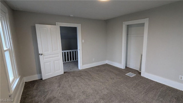 1111 2nd St NW, Canton, OH 44703 - unfurnished bedroom with dark carpet and a closet