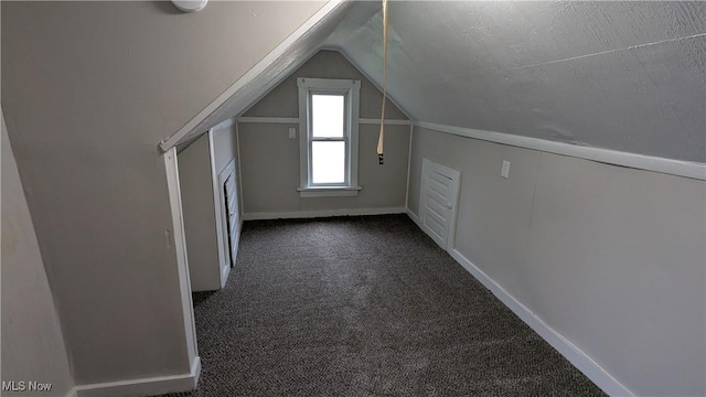 1111 2nd St NW, Canton, OH 44703 - bonus room featuring dark colored carpet and lofted ceiling