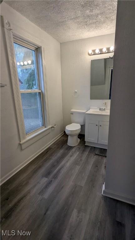 1111 2nd St NW, Canton, OH 44703 - half bathroom featuring a textured ceiling, vanity, and wood finished floors