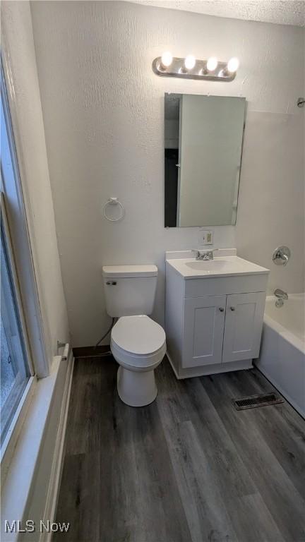 1111 2nd St NW, Canton, OH 44703 - full bath featuring vanity, wood finished floors, and bathing tub / shower combination