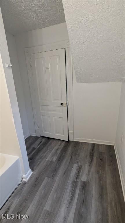 1111 2nd St NW, Canton, OH 44703 - additional living space with a textured ceiling and dark wood-style floors