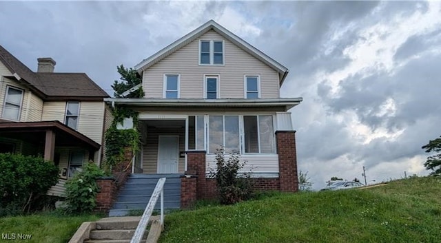 1111 2nd St NW, Canton, OH 44703 - view of front of house with a front yard and brick siding