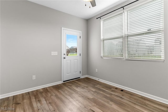 23563 Rebecca Ln, Columbia Station, OH 44028 - empty room with healthy amount of natural light, wood finished floors, and ceiling fan