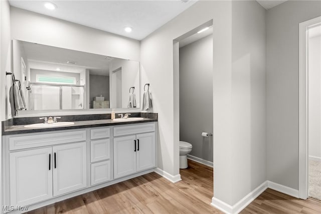 23563 Rebecca Ln, Columbia Station, OH 44028 - bathroom featuring wood finished floors, double vanity, an enclosed shower, and recessed lighting