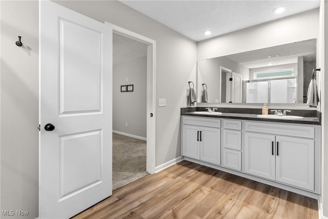 23563 Rebecca Ln, Columbia Station, OH 44028 - bathroom featuring double vanity, wood finished floors, a shower with shower door, and recessed lighting