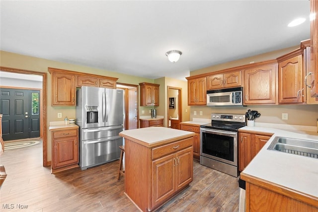2896 Highview Cir NW, Dellroy, OH 44620 - kitchen with appliances with stainless steel finishes, a center island, light countertops, and wood finished floors