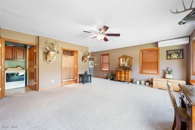2896 Highview Cir NW, Dellroy, OH 44620 - living room with washer / clothes dryer, a wall mounted AC, a ceiling fan, and light colored carpet