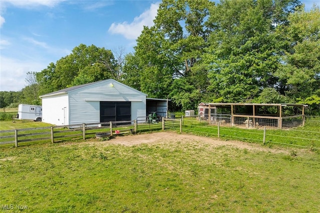 2896 Highview Cir NW, Dellroy, OH 44620 - view of yard featuring an exterior structure, an outbuilding, a garage, and view of scattered trees