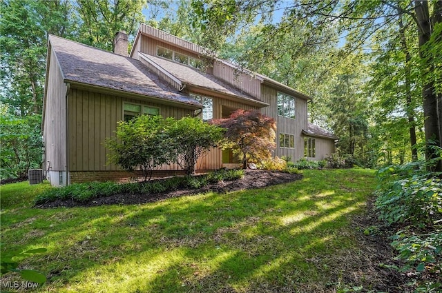 80 Hawthorne Ave, Rittman, OH 44270 - rear view of property featuring a lawn, a chimney, and a shingled roof