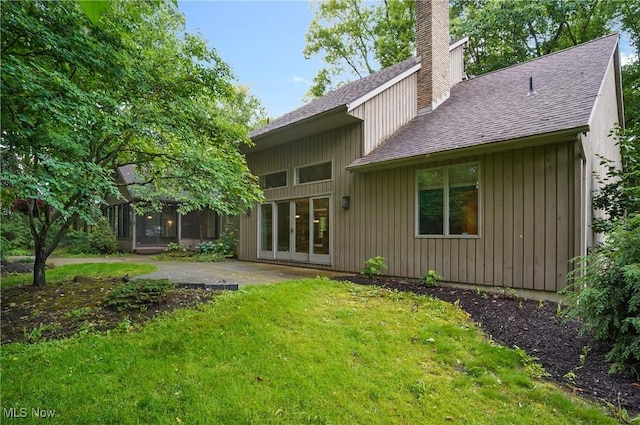 80 Hawthorne Ave, Rittman, OH 44270 - back of house with a shingled roof, a chimney, a lawn, and a patio