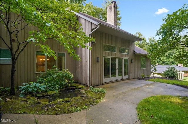 80 Hawthorne Ave, Rittman, OH 44270 - view of home's exterior featuring a chimney and a patio