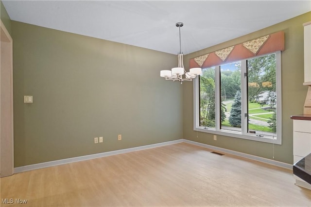 80 Hawthorne Ave, Rittman, OH 44270 - empty room featuring light wood finished floors and a chandelier