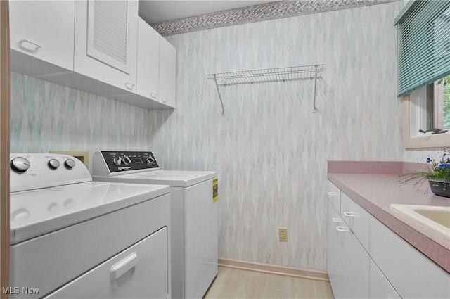80 Hawthorne Ave, Rittman, OH 44270 - washroom featuring cabinet space, washing machine and dryer, and light wood finished floors