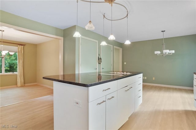 80 Hawthorne Ave, Rittman, OH 44270 - kitchen featuring electric cooktop, a chandelier, light wood-type flooring, and white cabinets