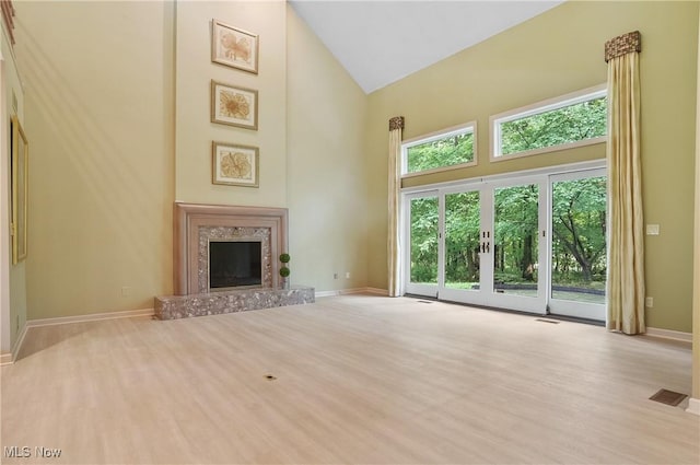 80 Hawthorne Ave, Rittman, OH 44270 - unfurnished living room with high vaulted ceiling, a fireplace, and wood finished floors