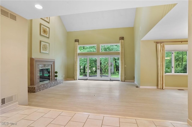 80 Hawthorne Ave, Rittman, OH 44270 - unfurnished living room with high vaulted ceiling, healthy amount of natural light, a high end fireplace, and wood finished floors