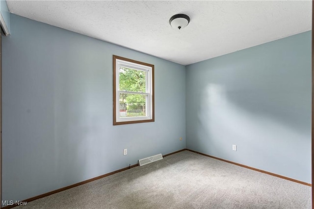 8132 Arlington Ave NW, North Canton, OH 44720 - carpeted spare room with baseboards and a textured ceiling