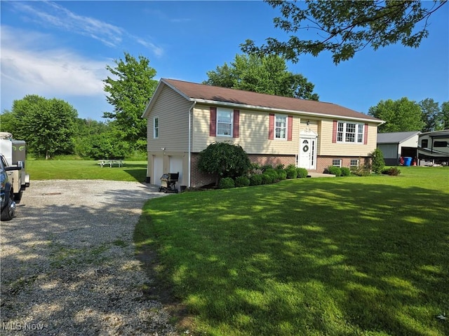 16535 Hosmer Rd, Middlefield, OH 44062 - split foyer home featuring a garage, gravel driveway, and a front yard