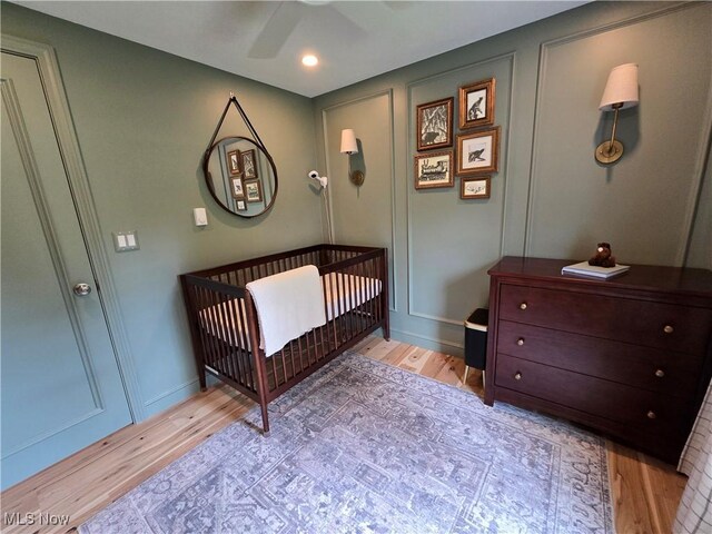 16535 Hosmer Rd, Middlefield, OH 44062 - bedroom featuring light wood-type flooring, a nursery area, ceiling fan, and recessed lighting