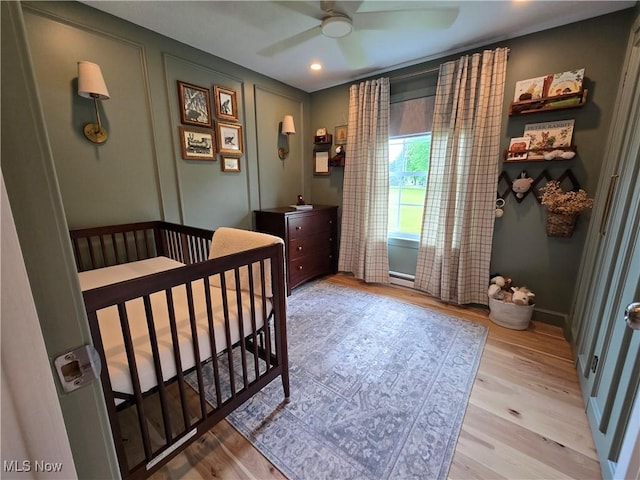 16535 Hosmer Rd, Middlefield, OH 44062 - bedroom with light wood-type flooring, a crib, and ceiling fan