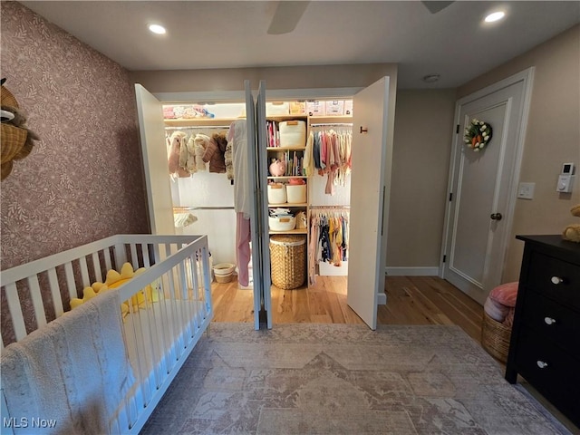 16535 Hosmer Rd, Middlefield, OH 44062 - bedroom with wood finished floors, a closet, wallpapered walls, recessed lighting, and a spacious closet