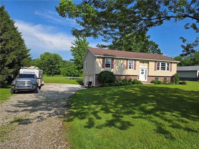 16535 Hosmer Rd, Middlefield, OH 44062 - split foyer home with driveway, a garage, and a front yard