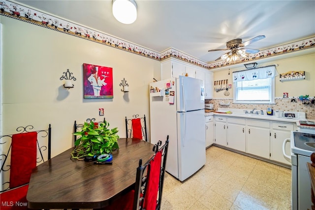 24270 Glenforest Rd, Euclid, OH 44123 - kitchen featuring white appliances, light floors, a ceiling fan, white cabinetry, and light countertops