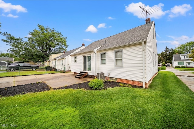 24270 Glenforest Rd, Euclid, OH 44123 - rear view of house featuring entry steps, a chimney, roof with shingles, and a patio area