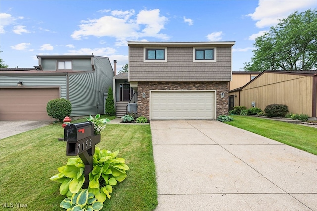 7152 Rippling Brook Ln, Concord, OH 44060 - view of front of home with stone siding, a front lawn, concrete driveway, and a garage