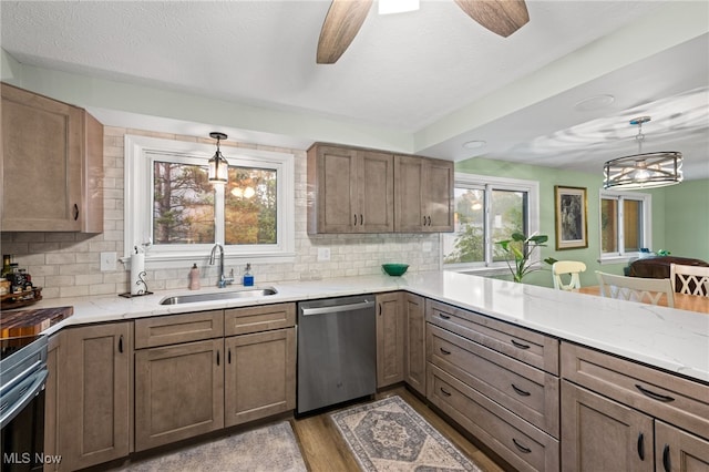 7152 Rippling Brook Ln, Concord, OH 44060 - kitchen featuring stainless steel dishwasher, tasteful backsplash, ceiling fan, and hanging light fixtures