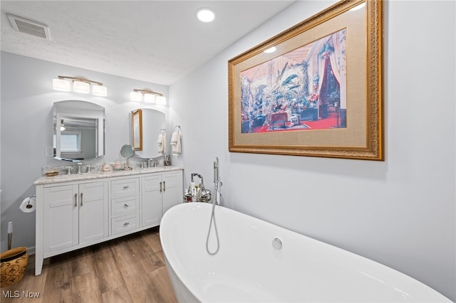 7152 Rippling Brook Ln, Concord, OH 44060 - full bathroom featuring double vanity, a soaking tub, wood finished floors, and recessed lighting