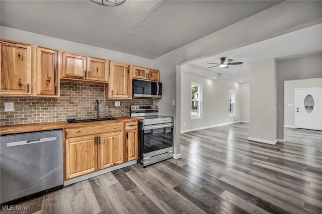 397 Furnace Rd, Conneaut, OH 44030 - kitchen featuring stainless steel appliances, wooden counters, dark wood-style floors, tasteful backsplash, and a ceiling fan