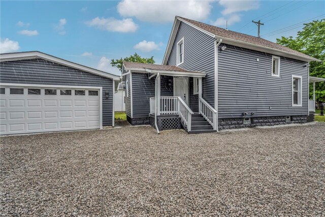 397 Furnace Rd, Conneaut, OH 44030 - view of front of home with a garage, an outbuilding, and a shingled roof